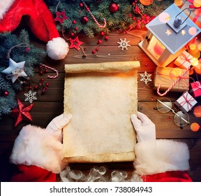 Santa Claus Desk Reading Wish List With Ornament And Christmas Gift
 - Shutterstock ID 738084943