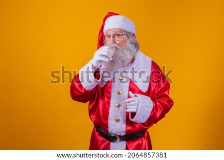 Santa Claus drinking a glass of water on yellow background with space for text. Health and hydration concept
