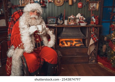 Santa Claus drinking hot tea or cocoa while sitting at home - Powered by Shutterstock