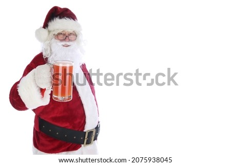 Santa Claus enjoys a mug of Michelada.  Spicy Mexican Beer and Tomato Juice Cocktail. Michelada is the Mexican Bloody Mary. 