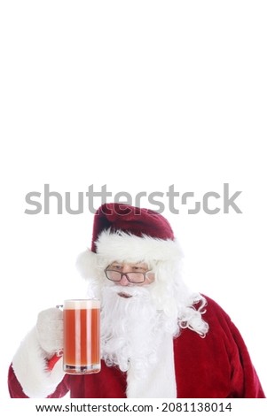 Santa Claus enjoys a mug of Michelada.  Spicy Mexican Beer and Tomato Juice Cocktail. Michelada is the Mexican Bloody Mary. 