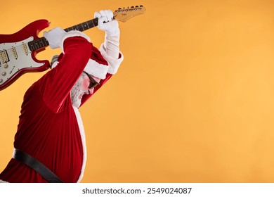 Santa Claus enthusiastically playing an electric guitar in vibrant red outfit. Energetically strumming against a warm background, capturing holiday rock spirit - Powered by Shutterstock