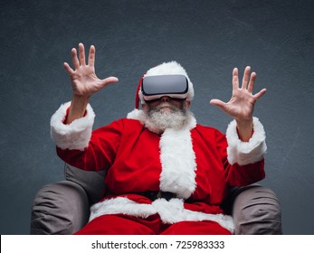 Santa Claus experiencing virtual reality, he is wearing VR glasses and interacting with a virtual environment - Powered by Shutterstock