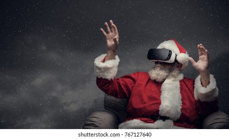 Santa Claus experiencing virtual reality surrounded by snow falling, he is wearing VR glasses and interacting with a virtual environment - Powered by Shutterstock