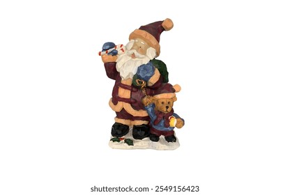 A Santa Claus figurine standing next to a teddy bear. Santa is wearing a red and white suit with a fluffy white beard and hat. He is holding a bag of gifts in one hand and a candy cane in the other.  - Powered by Shutterstock