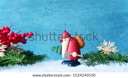 Santa Claus with fir-tree and ax in the snow