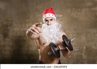 Santa Claus fitness guy pointing you for training after Christmas