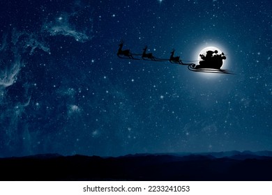 Santa Claus flies on Christmas Eve in the night sky with snow - Powered by Shutterstock