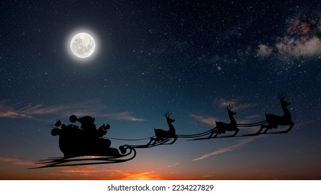 Santa Claus flies on Christmas Eve in the night sky with snow - Powered by Shutterstock