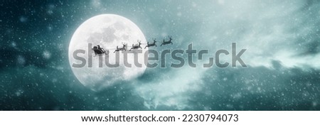 Santa Claus flying on his sleigh over the moon on Christmas night