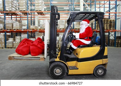 Santa Claus As A Forklift Operator At Work In Warehouse