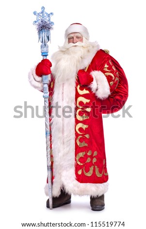 Santa Claus in full growth with a staff and a bag