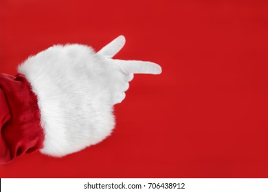 Santa Claus Hand Against Red Background