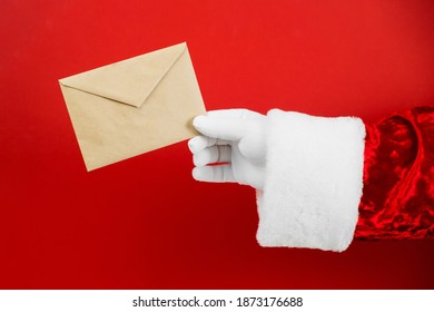 Santa Claus Hand Hold Craft Envelope With Letter, Sending Post Card. Christmas Mail. Wish List