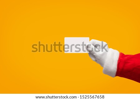 Santa Claus hand holding blank plastic credit card over isolated background with Clipping Path. Shopping, Sales, Giving Gift for Black Friday, Christmas and New Year 2019 concepts.