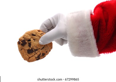 Santa Claus Hand Holding A Chocolate Chip Cookie Over A White Background. Horizontal Format Showing Santa's Hand A Arm Only.