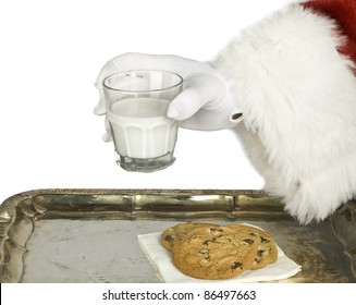 Santa Claus Hand Holding Milk With A Chocolate Chip Cookie