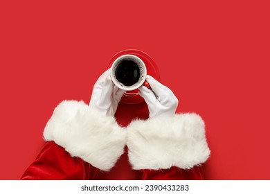 Santa Claus hands with cup of aromatic coffee on red background, closeup - Powered by Shutterstock