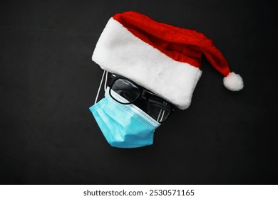 Santa Claus hat, glasses and nose with face mask on red background. Christmas or New Year celebration concept. Christmas reindeer made from protective face mask and decorations. Health care concept.

 - Powered by Shutterstock