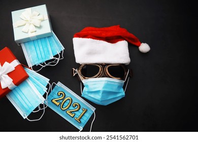 Santa Claus hat, glasses and nose with face mask on red background. Christmas or New Year celebration concept. Christmas reindeer made from protective face mask and decorations. Health care concept.

 - Powered by Shutterstock