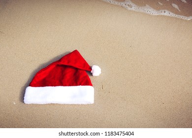 Santa Claus Hat On Caribbean Beach. Christmas Background