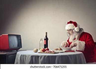 Santa Claus Having Dinner In Front Of The Tv