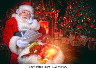 Santa Claus Is At His Home Reading Letters With Wishes From Children. Merry Christmas And Happy New Year. Miracle Time.