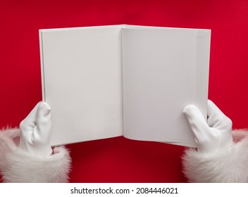 Santa Claus Holding A Book With Blank Pages. Christmas Book Mockup