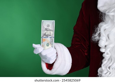 Santa Claus holding dollar banknotes on green background, closeup - Powered by Shutterstock