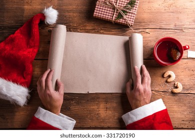 Santa Claus Holding An Empty Wish List In His Hands