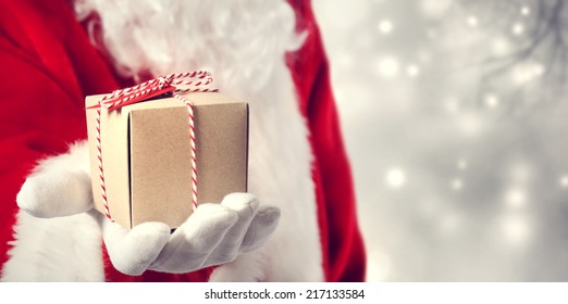 Santa Claus Holding A Gift In His Hand