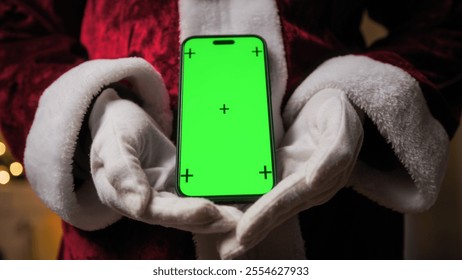 Santa Claus holding a phone with green screen  - Powered by Shutterstock