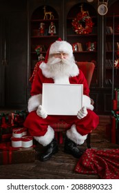 Santa Claus Holding White Frame In His Hands