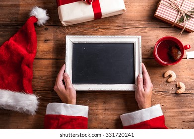 Santa Claus Holding White Picture Frame In His Hands