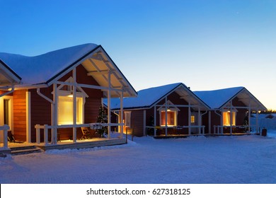 Santa Claus Holiday Village Houses in Lapland, Finland, on Arctic Circle in winter. After sunset