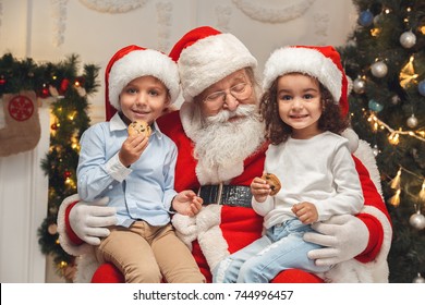 Santa Claus with kids indoors christmas celebration concept - Powered by Shutterstock