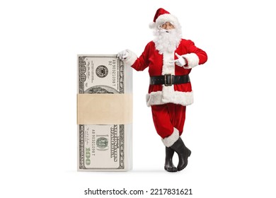 Santa claus leaning on a stack of money and pointing isolated on white background - Powered by Shutterstock