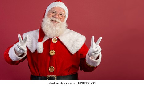 Santa Claus Looking At The Camera. Christmas Is Coming. Merry Christmas. Peace. V Sign.