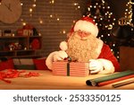 Santa Claus making Christmas gift at home