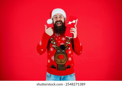 Santa Claus man at New Year sale. Santa man hold holiday shopping gift isolated on red. Xmas present and gift. Christmas shopping sale. Happy New Year. Xmas holiday present. Christmas Eve - Powered by Shutterstock