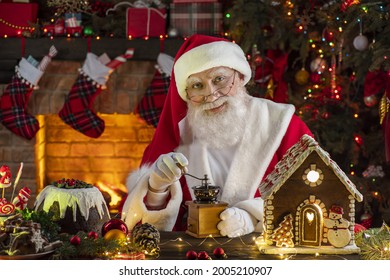 Santa Claus near fireplace and Christmas tree. Festive interior inside wooden house, New Year's cheerful mood Spirit of Christmas. Senior man with real white beard cosplay Father Christmas. - Powered by Shutterstock