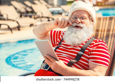 Santa Claus Near The Pool Holiday Vacation Concept