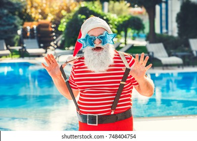 Santa Claus Near The Pool Holiday Vacation Concept