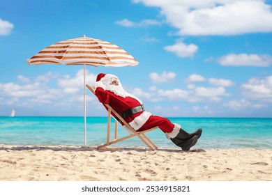 Santa claus on a summer vacation sunbathing by the sea on a sandy beach - Powered by Shutterstock