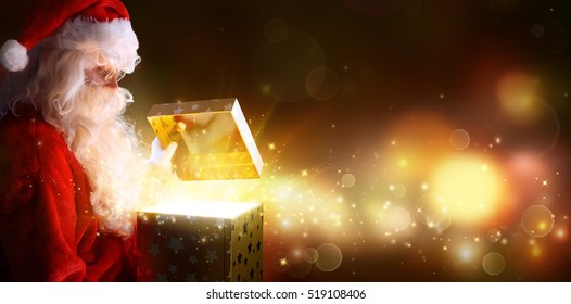 Santa Claus Opening Christmas Present With Shiny Stars
