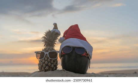 Santa Claus pineapple and watermelon couple wearing stylish sunglasses on the sand contrasting with the sea. wearing a christmas hat Christmas and New Year holiday ideas on the beach, Patong, Phuket - Powered by Shutterstock