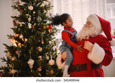 Santa Claus Playing With Cute African American Child At Home