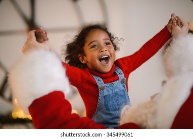 Santa Claus Playing With Cute African American Child At Home