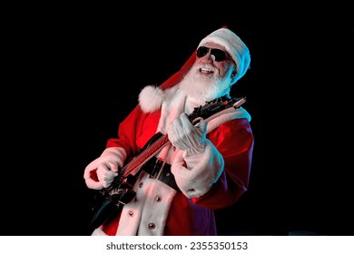 Santa Claus playing the electric guitar in a nightclub at a Christmas and New Year party or Corporate events. Senior rockstar guitar player as Santa at a rock concert, festival, or celebration. - Powered by Shutterstock