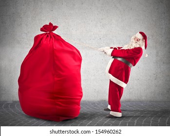 Santa Claus pulls big red sack - Powered by Shutterstock